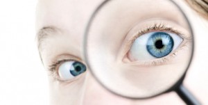 Eye looking thorough magnifying glass image